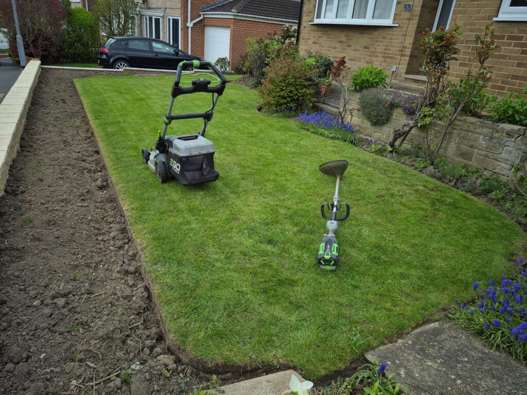 Freshly mown lawn with professional mowing equipment in Wakefield