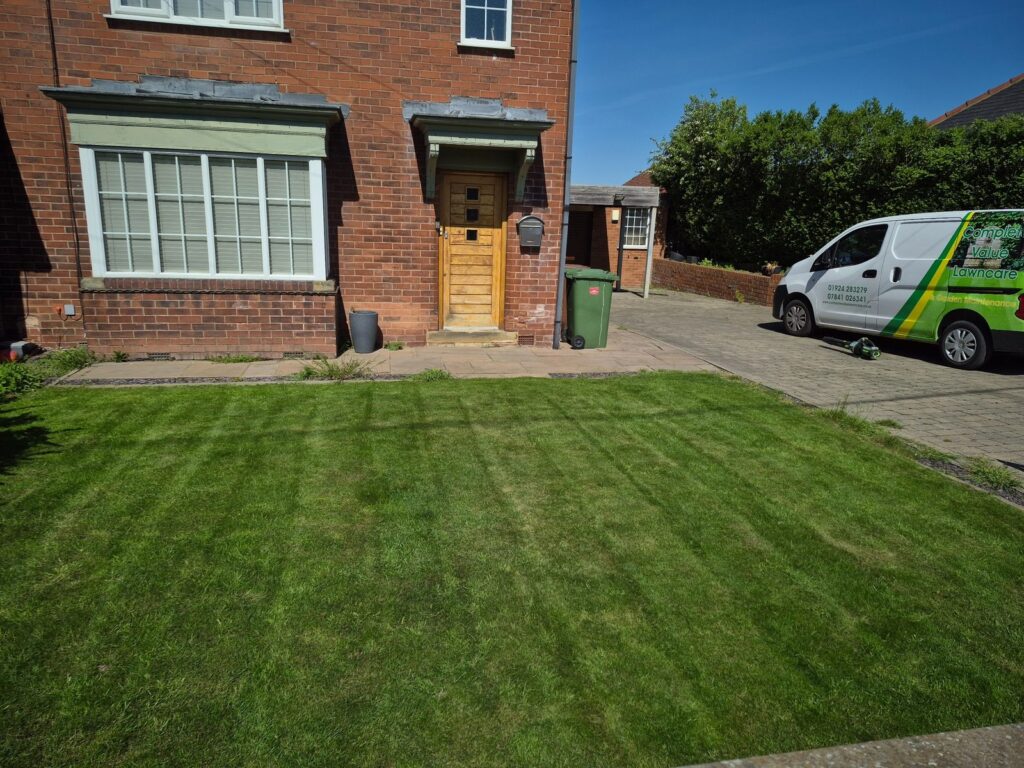 Maintained lawn with Complete Value Lawncare van at a Wakefield home