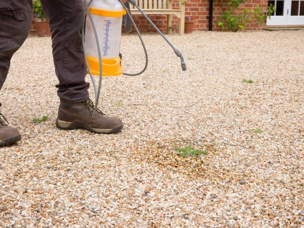 Professional hard surface weed control treatment on a gravel driveway