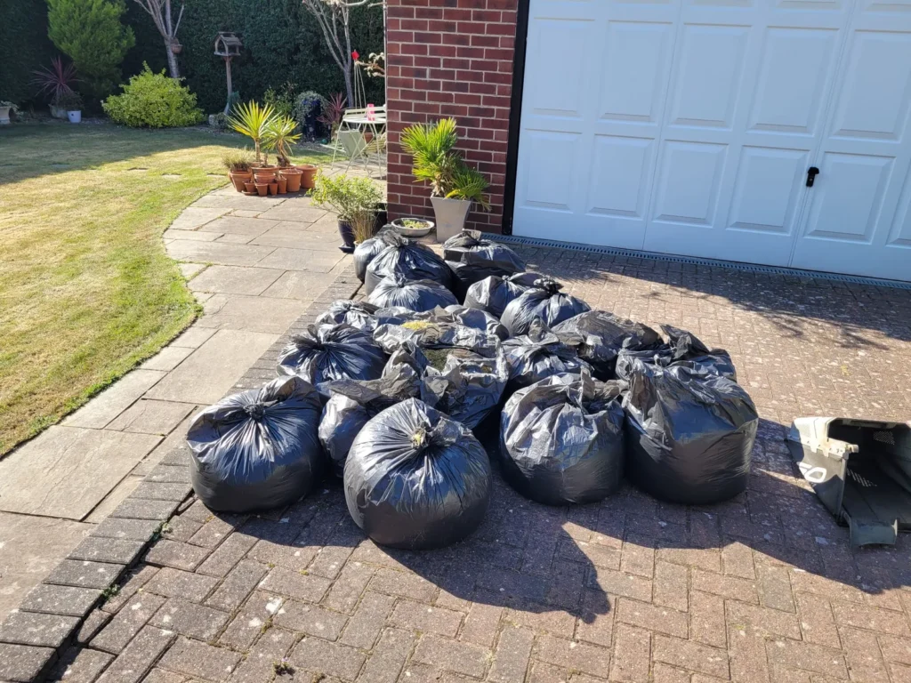Bags of thatch and moss removed after lawn scarification in Wakefield